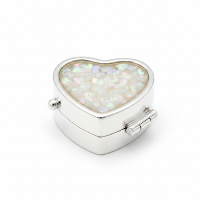 Silver 925 heart pill box with white pearl opal resin in open heart bezel top on white background