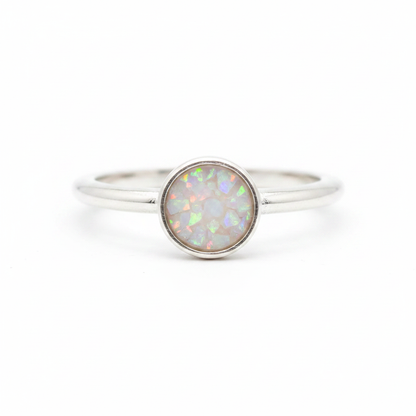 925 sterling silver 6mm cabochon rubover bezel memorial ring with white pearl opal and mica shimmer in flat resin setting on white background