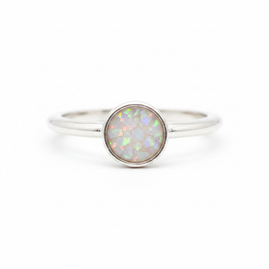925 sterling silver 6mm cabochon rubover bezel memorial ring with white pearl opal and mica shimmer in flat resin setting on white background