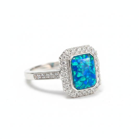 925 sterling silver rectangle CZ memorial ring with blue teal opal flakes in rectangular bezel on white background