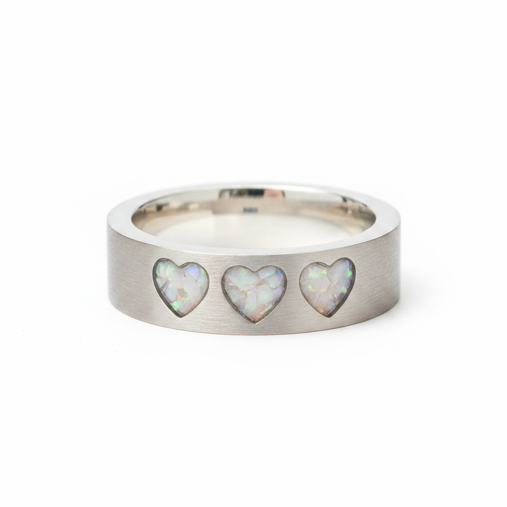 925 sterling silver three hearts memorial band ring with white pearl opal and mica shimmer in recessed heart settings on white background