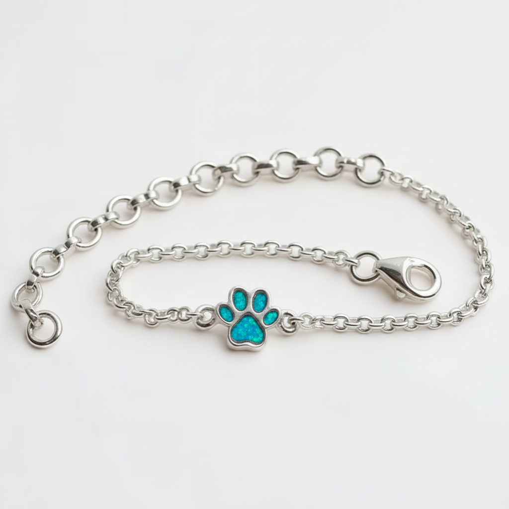 Mini paw charm silver bracelet with blue teal opal resin in paw charm, white background