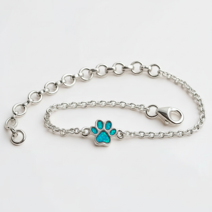 Mini paw charm silver bracelet with blue teal opal resin in paw charm, white background