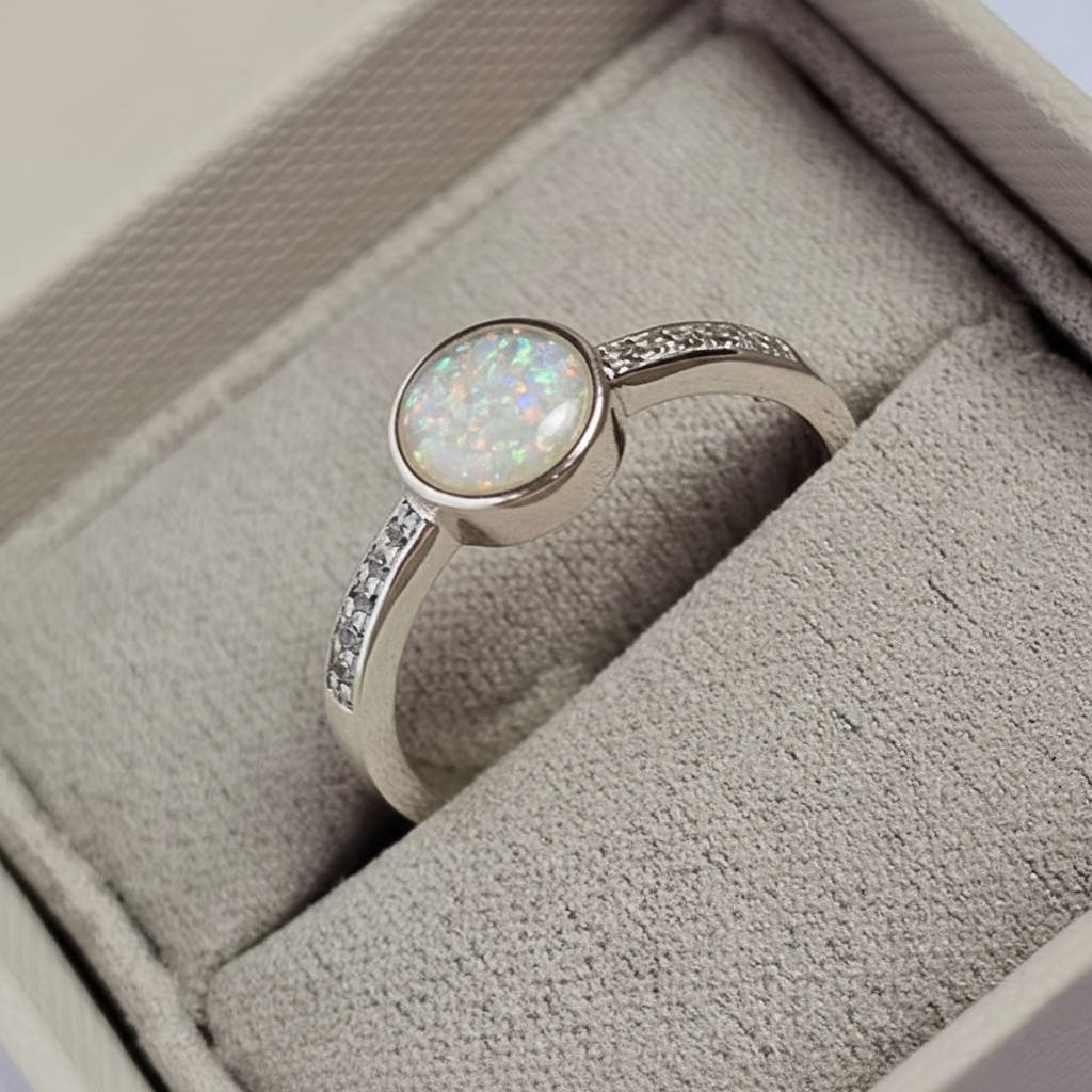 Silver 925 full shank CZ ring with white pearl opal resin in 6mm central setting on white background