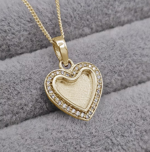 9ct yellow gold CZ crystal heart pendant on curb chain, front view showing CZ halo surround and recessed heart-shaped centre bezel