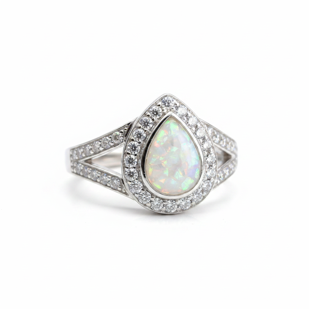925 sterling silver split shank pear memorial ring with white pearl opal flakes in pear bezel on white background