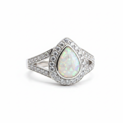 925 sterling silver split shank pear memorial ring with white pearl opal flakes in pear bezel on white background