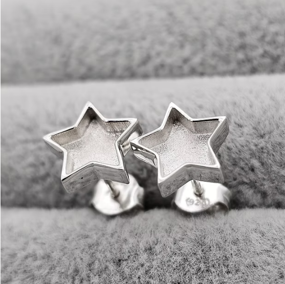 Silver 925 star stud earrings showing butterfly backs on grey velvet — blank silver