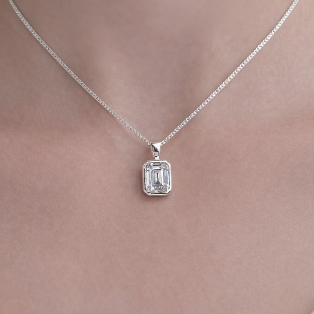 Emerald Cut Secretly Set CZ 925 Silver Memorial Pendant worn on neck — white background