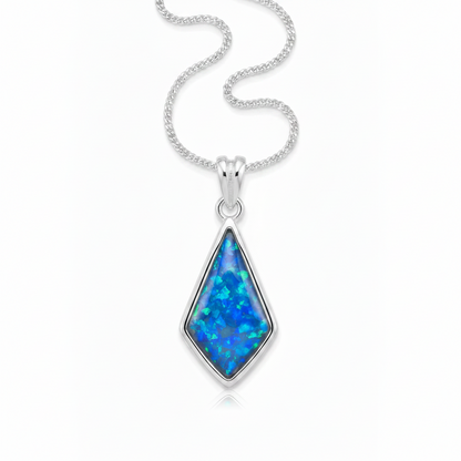 Silver 925 kite shaped memorial pendant with blue opal resin on chain, white background