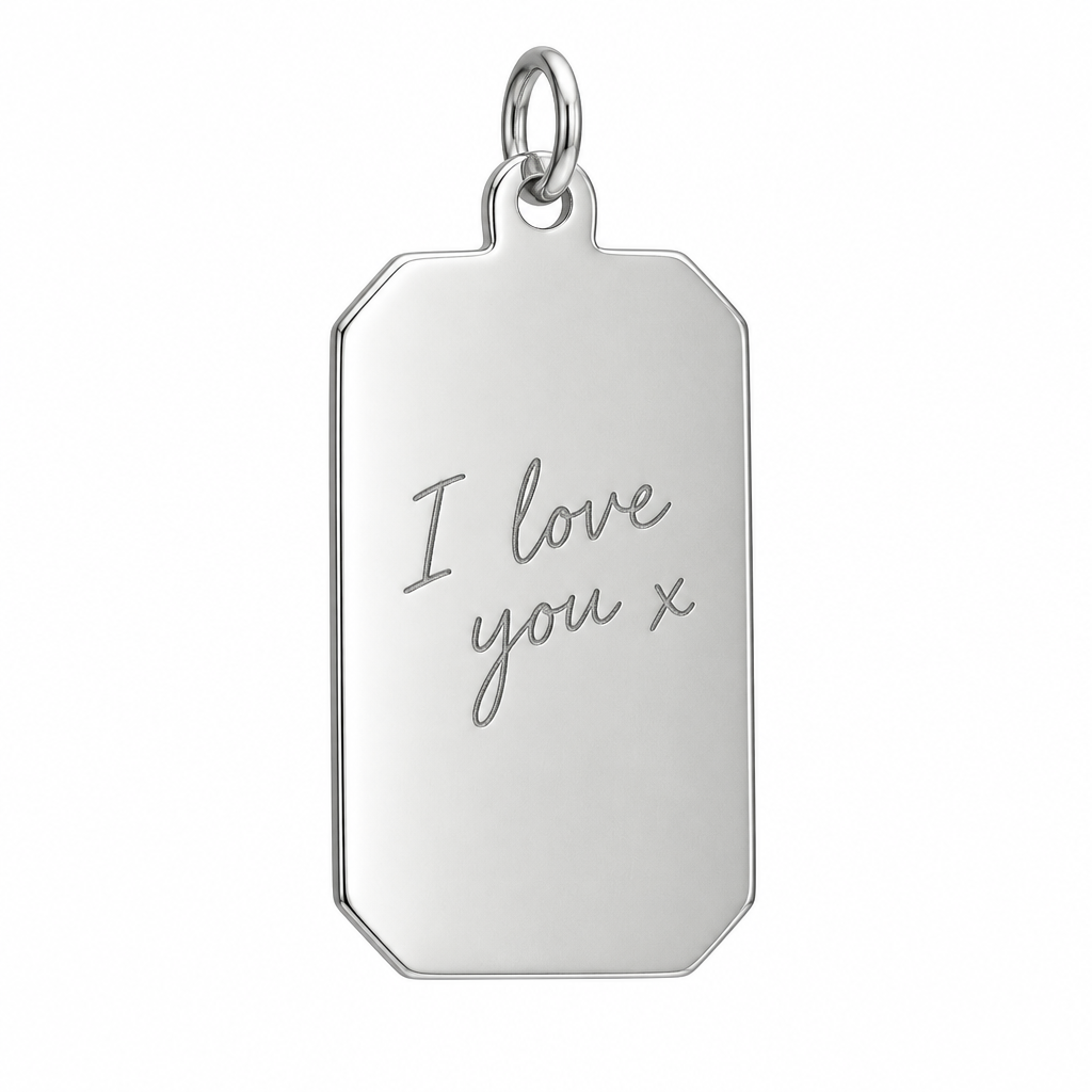 Illustrative handwriting engraving on plain 925 Sterling Silver clipped-corner rectangular pendant against white