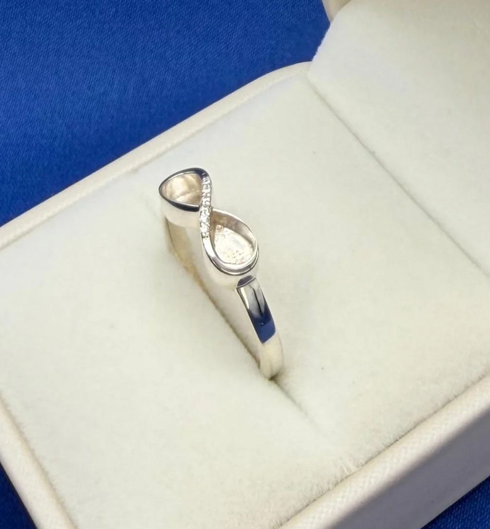 925 sterling silver CZ infinity ring side view showing pear bezel detail and cubic zirconia crossover stones