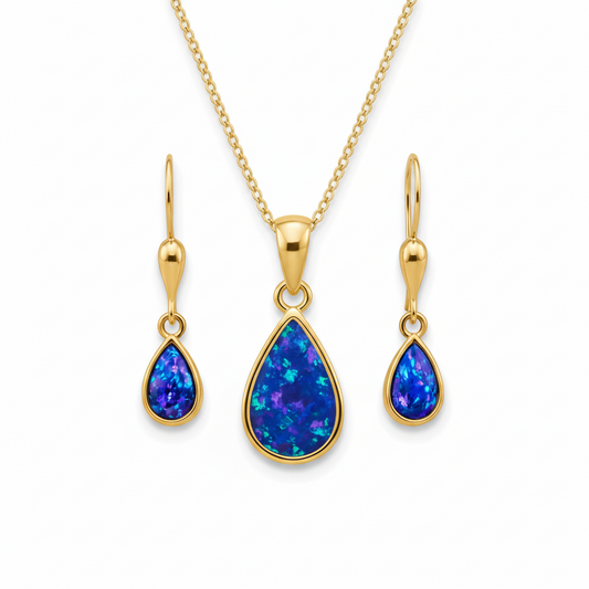 9ct gold teardrop memorial jewellery set with deep blue iridescent opal flakes – pendant earrings and chain flat-lay white background