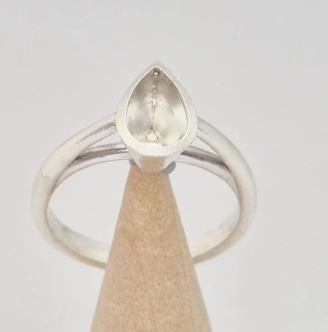 925 sterling silver pear cut bezel cathedral memorial ring — front view on wooden cone showing pear teardrop bezel and split cathedral shank