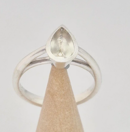 925 sterling silver pear cut bezel cathedral memorial ring — front view on wooden cone showing pear teardrop bezel and split cathedral shank