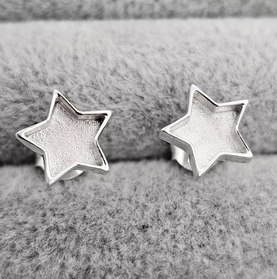 Silver 925 star stud earrings on grey velvet — blank silver front view