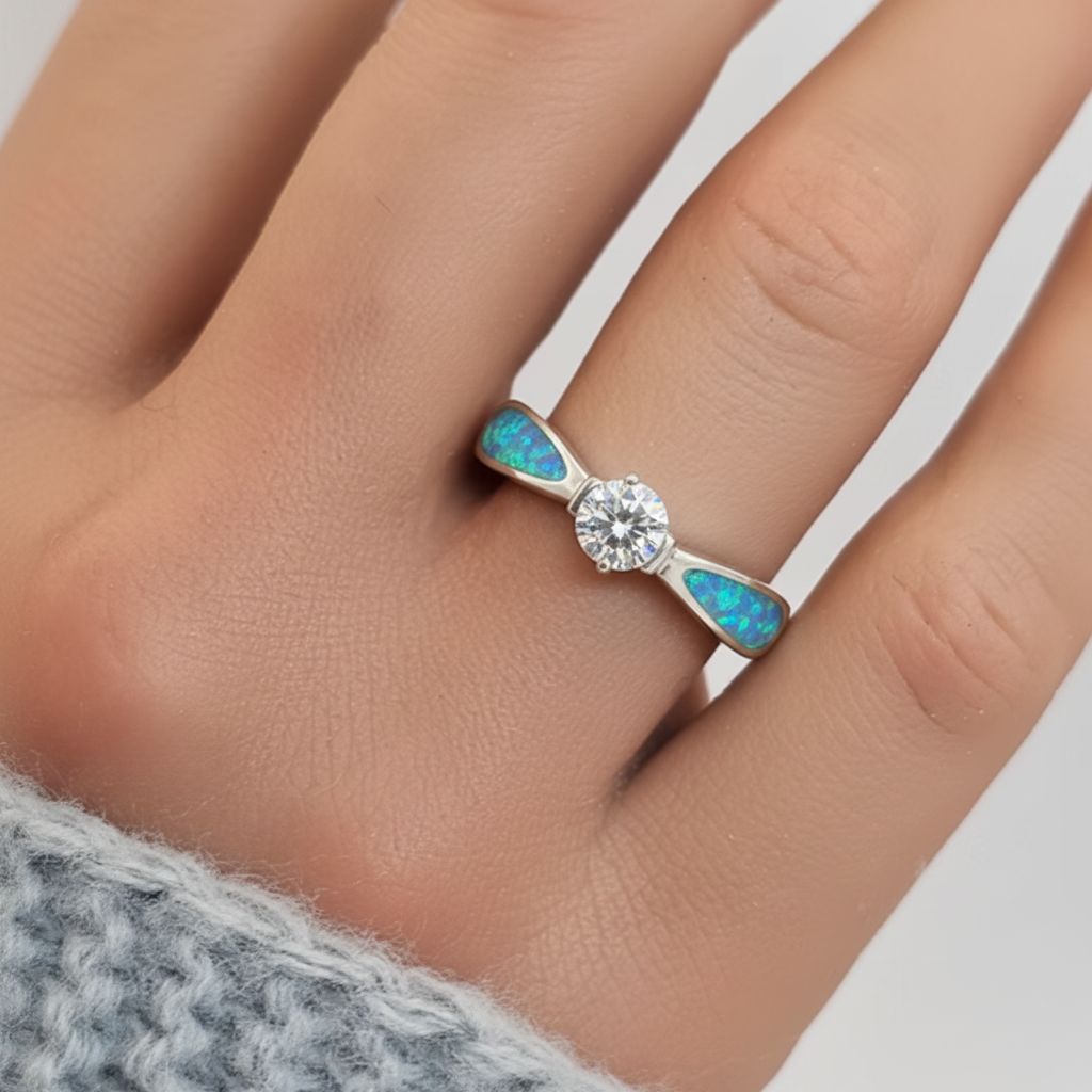 Solitaire CZ 925 silver ring with blue teal opal resin worn on finger white background