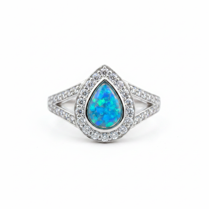 925 sterling silver split shank pear memorial ring with blue teal opal flakes in pear bezel on white background