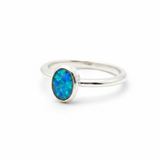 925 sterling silver 6x4mm oval bezel memorial ring with blue teal opal flakes in flat resin setting on white background