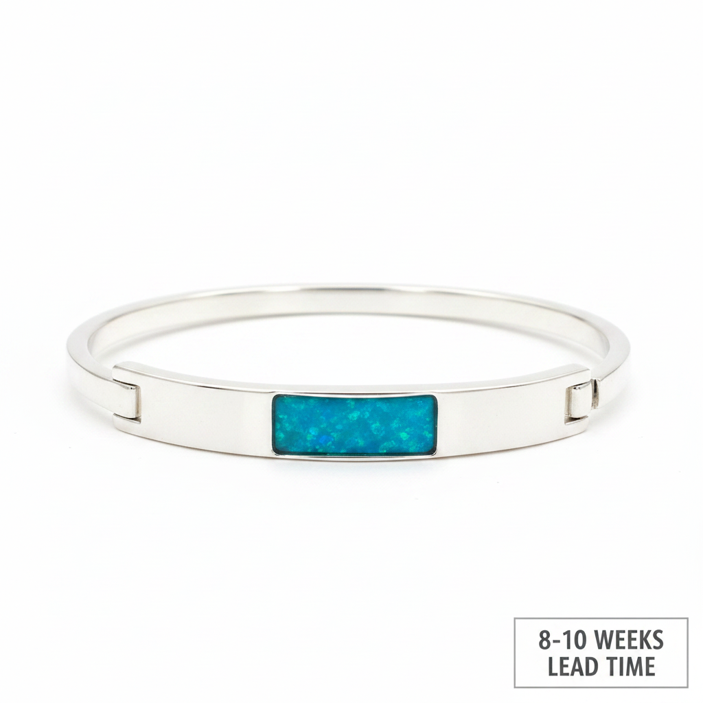 Solid weighted 925 silver bar bangle with blue teal opal resin in rectangular bezel, white background, 8-10 weeks lead time label
