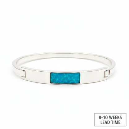 Solid weighted 925 silver bar bangle with blue teal opal resin in rectangular bezel, white background, 8-10 weeks lead time label