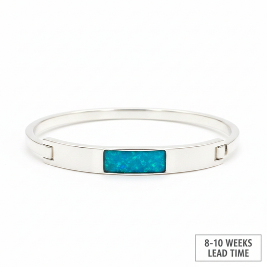 Solid weighted 925 silver bar bangle with blue teal opal resin in rectangular bezel, white background, 8-10 weeks lead time label