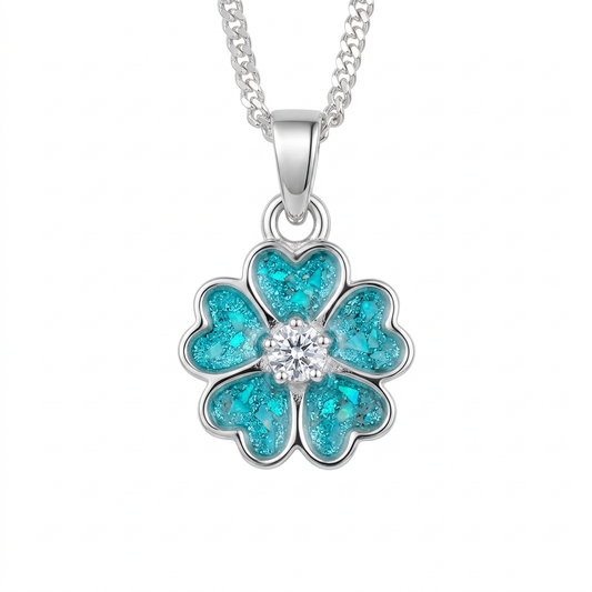 Illustrative silver forget-me-not memorial pendant with turquoise opal-flake heart-shaped petals and central CZ