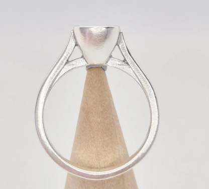 925 sterling silver 6mm cushion bezel cathedral memorial ring — back view on wooden cone showing open triangular cathedral shank cutouts