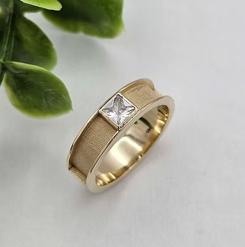 9ct yellow gold 6mm front face CZ ring, angled view showing princess cut CZ stone in centre of brushed gold band with polished raised edges