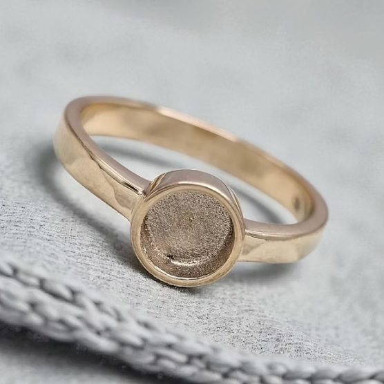 9ct yellow gold plain round 6mm bezel ring on grey fabric