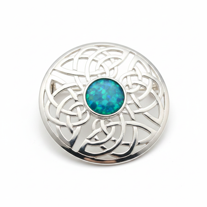 Silver 925 Celtic knot round brooch with blue teal opal resin in 8mm central setting on white background