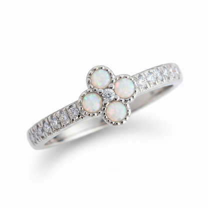 Petite clover 925 silver CZ ring with white pearl opal resin in four milgrain bezels on white background