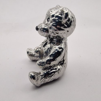 Chrome mirror-polished stainless steel teddy bear memorial ornament side view showing sitting pose and detail