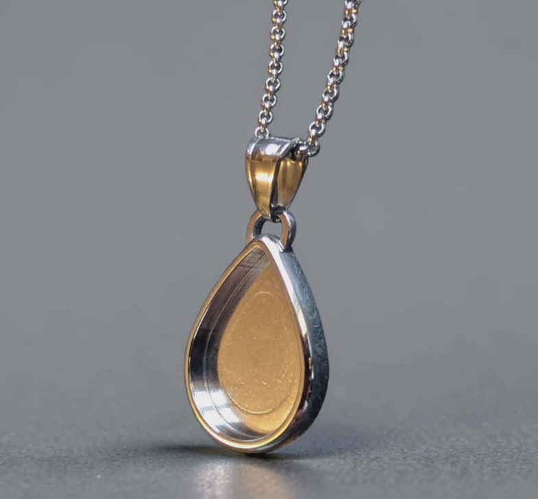 316L stainless steel two-tone eternal drop pendant necklace showing polished silver outer bezel rim with warm gold PVD inner face and gold bail on fine rolo chain