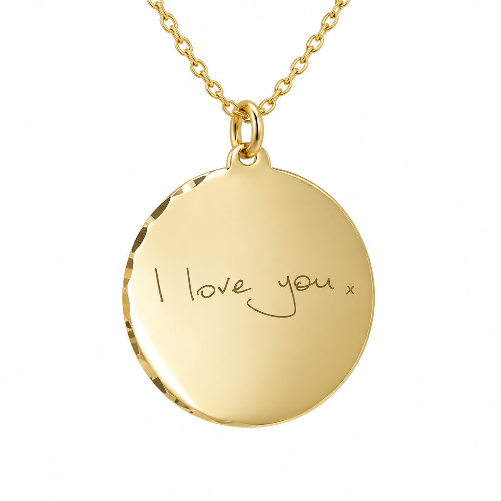 Illustrative handwriting engraving on subtle scalloped 9ct yellow gold round disc pendant on chain, white background