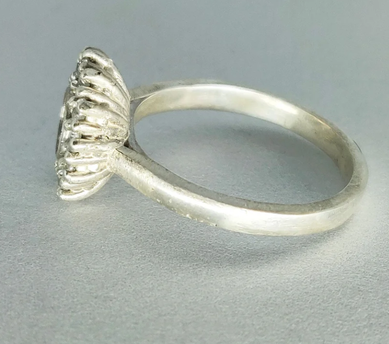 925 sterling silver round CZ cluster halo memorial ring — side profile on grey surface showing slim cathedral shank height and ribbed gallery detail
