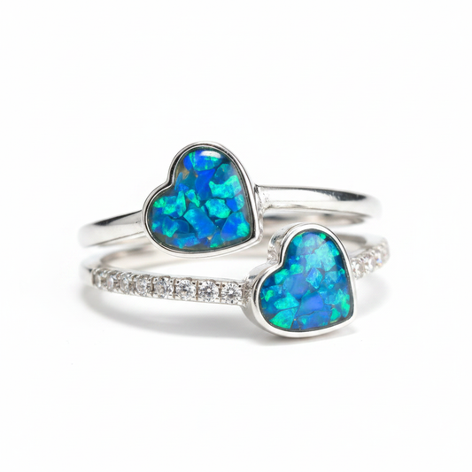 925 sterling silver double heart CZ memorial ring with blue teal opal flakes in twin heart bezels on white background