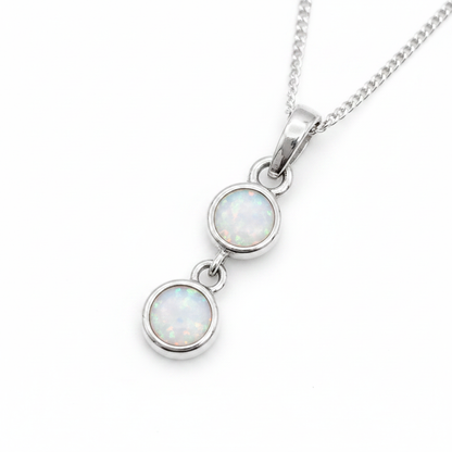 Two Round Bezel 925 Silver Memorial Pendant with white pearl opal resin in both bezels — white background