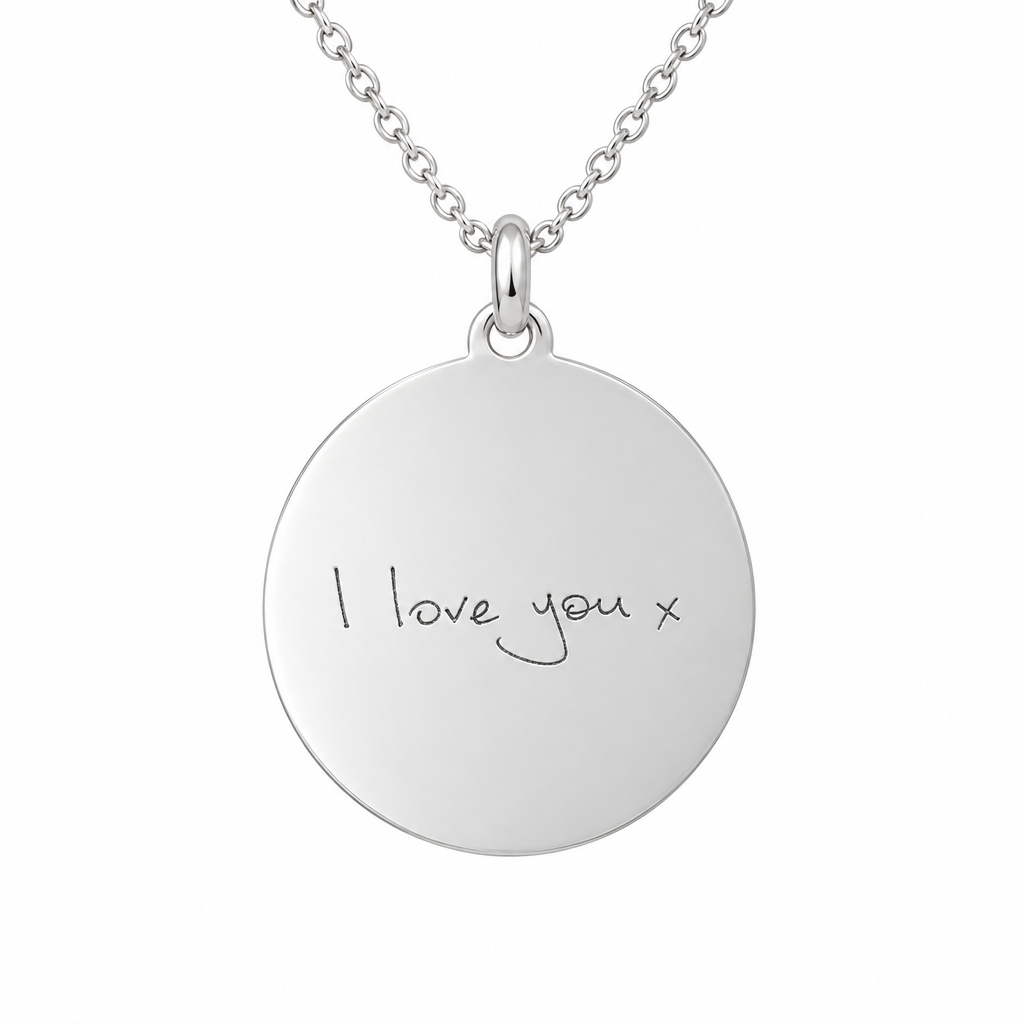 Illustrative handwriting engraved plain round 925 sterling silver disc pendant with silver chain on white background