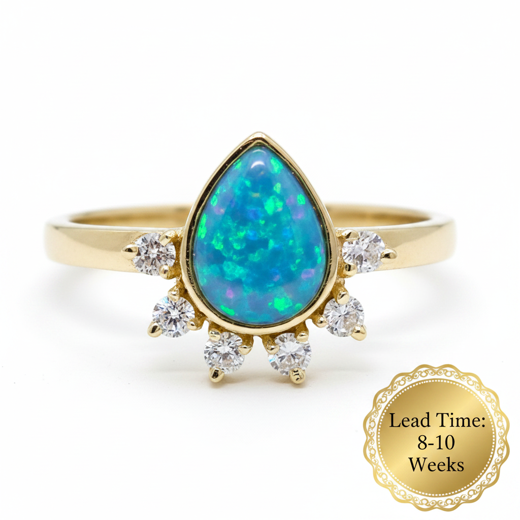 9ct gold CZ raindrop ring with blue teal opal resin, white background, lead time 8-10 weeks sticker