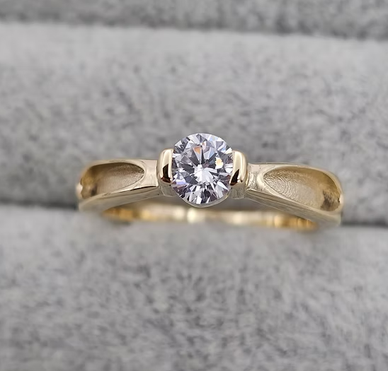 9ct yellow gold CZ solitaire ring top-down view showing brilliant round cubic zirconia and crossover shank detail