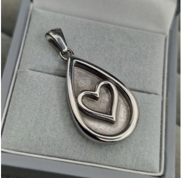Stainless steel teardrop heart pendant in jewellery box showing three resin spaces and bail for chain