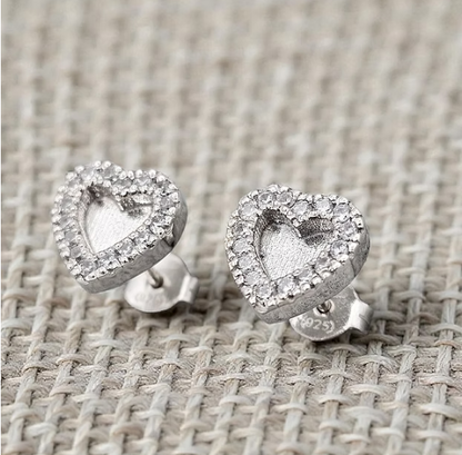 Silver 925 heart CZ halo stud earrings on woven fabric — blank silver