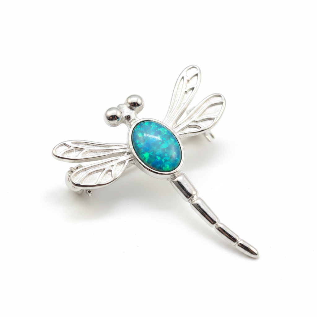 Silver 925 filigree dragonfly brooch with blue teal opal resin in 7x5mm central setting on white background