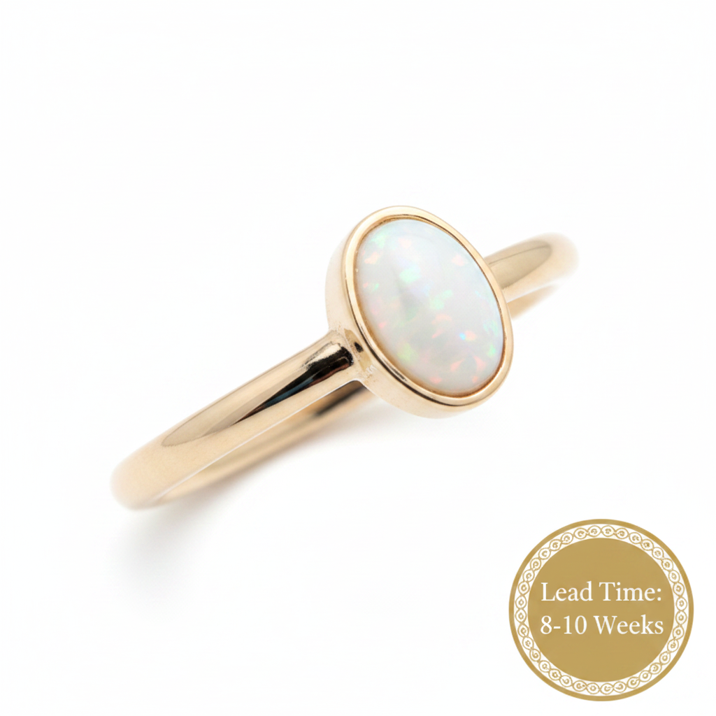 9ct gold plain oval ring with white pearl opal resin in oval bezel, white background, lead time 8-10 weeks sticker