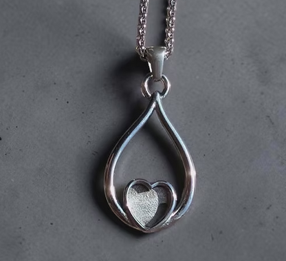 316L stainless steel eternal heart loop pendant necklace showing open teardrop loop with floating heart bezel on fine rolo chain
