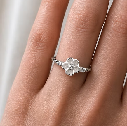 Forget-me-not CZ 925 silver ring worn on finger — lifestyle shot