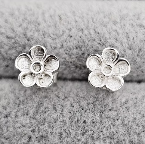 Silver 925 forget-me-not flower stud earrings front view on grey fabric — blank silver