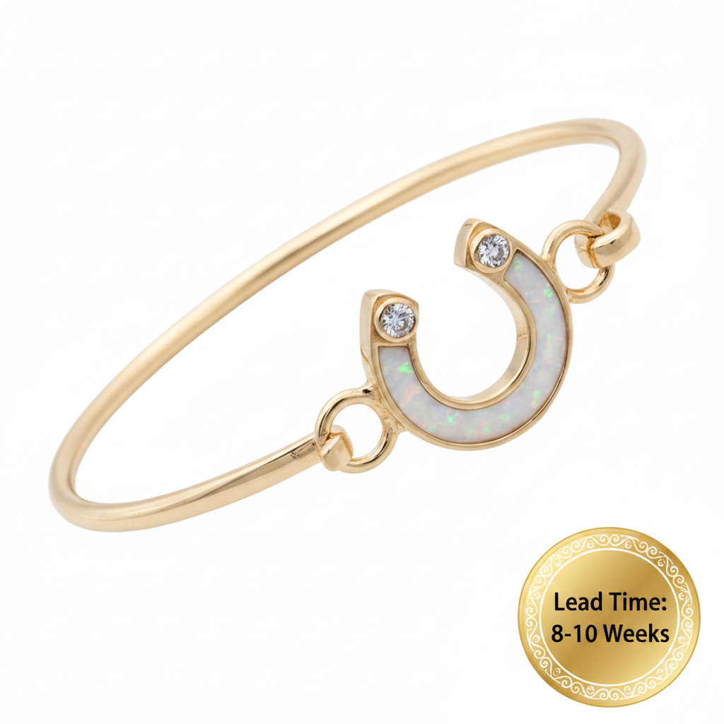 9ct gold horseshoe CZ bangle with white pearl opal resin in horseshoe centre, white background, lead time 8-10 weeks sticker