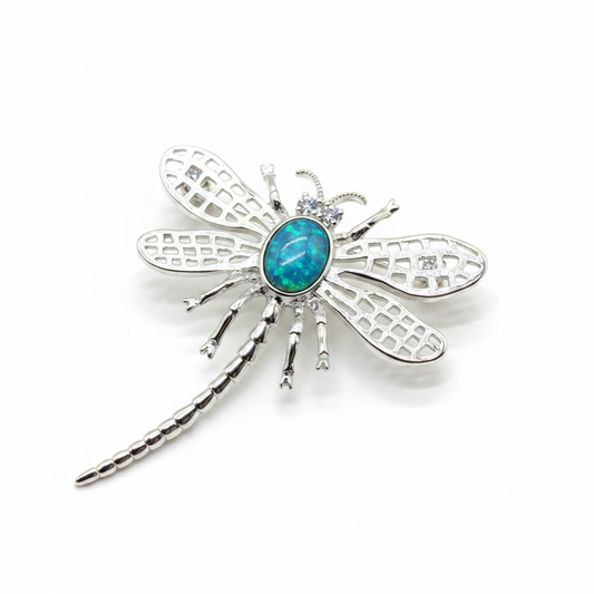 Silver 925 lattice wing dragonfly brooch with blue teal opal resin in 8x6mm central setting on white background